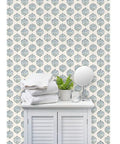 Sick Periwinkle Matte Wallpaper With Subtle Linen Texture covering wall behind a cabinet with towels and greenery.