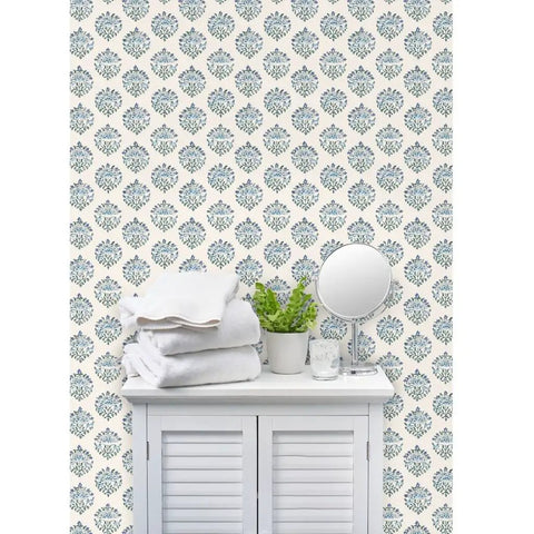Sick Periwinkle Matte Wallpaper With Subtle Linen Texture covering wall behind a cabinet with towels and greenery.
