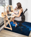 Chair Mat for Hardwood Floors 48x36 Inches Under Desk Protector for Rolling Office Chair on Low-Pile Carpet Anti-Slip Floor Shield in Blue Starry Sky Pattern for Go-To Home Office Setup installed under desk with person using chair.