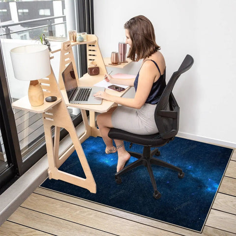 Chair Mat for Hardwood Floors 48x36 Inches Under Desk Protector for Rolling Office Chair on Low-Pile Carpet Anti-Slip Floor Shield in Blue Starry Sky Pattern for Go-To Home Office Setup installed under desk with person using chair.