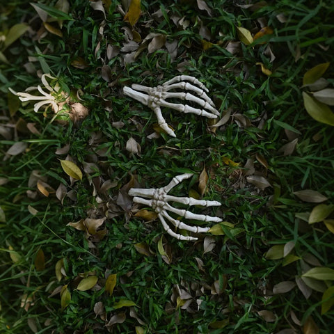 Left And Right Skeleton Hands 8 Inch Spooky Bones Halloween Decor on grass, realistic bone look, all weather plastic