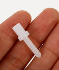 Shutter Repair Kit with Replacement Pins and Staples for Easy Louver Movement Fixes Up Your Broken Window Covers No Sweat with Durable Plastic and Metal Hardware for Quick DIY Repairs that Really Hold Tight like a Charm. White plastic pin held in hand for quick shutter repairs.