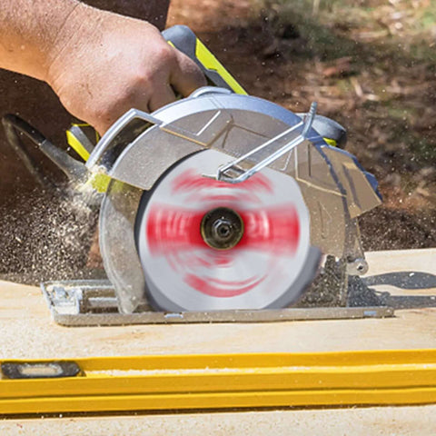 Cordless circular saw in use, yellow/black body cutting wood with a 5-1/2-inch carbide-tipped blade