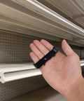 Hand holding Beefy U Shaped Shelf Brackets With Center Hole Heavy Duty Black Metal Brackets for shelving installation