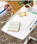 Height Adjustable Rolling Laptop Desk With Rock Solid Surface Top Portable Mobile Workstation Cart And Easy Glide Base with pens and book on top.