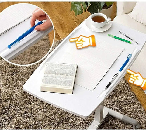 Height Adjustable Rolling Laptop Desk With Rock Solid Surface Top Portable Mobile Workstation Cart And Easy Glide Base with pens and book on top.