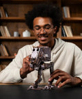 Person assembling a Wooden Star Wars AT ST Walker 3D Puzzle Featuring Smooth Shifting Gear System That Delivers Real Walking Motion.