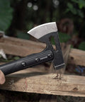 Close-up of Camping Hatchet For Real Wood Chopping And Outdoor Survival with stainless steel blade and anti-slip grip in use.