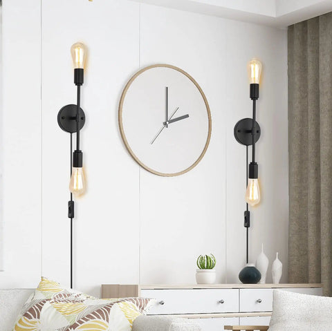 Lit Two-Light Black Bathroom Vanity Light Fixtures Set Of Two, modern industrial design, mounted on a living room wall.
