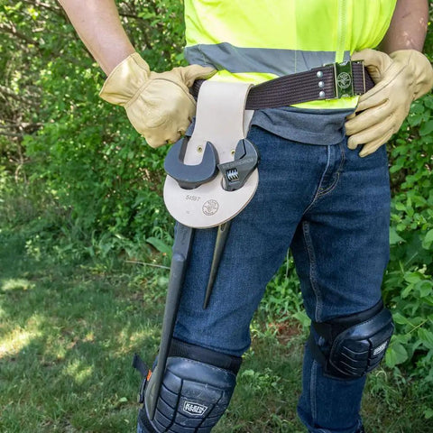 Person wearing Leather Riveted Spud Wrench Holder With Tunnel Connection For Dual Spud Wrenches And Adjustable Head Construction Wrench