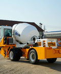 Tough As Nails Real Heavy Duty Mobile Concrete Mixer With Reliable Hydraulic Loading System Built Tough For Rugged Construction Sites And High Volume Pours, yellow and white truck on construction site.