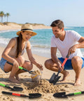 Couple using Six Piece Small Garden Shovel Set With 16.93 Inch Long Handles on a beach, showcasing heavy duty trowels and spades.