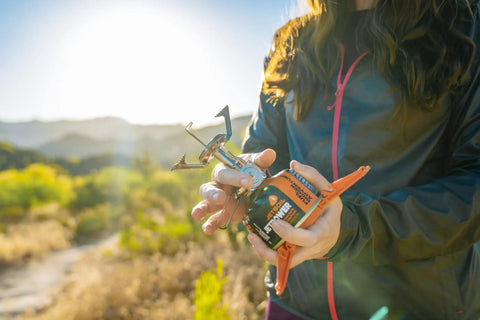 Person holding Ultralight Camping Stove That Boils Water In About 3 Minutes, Packs Ultra Compact, Halves Fuel Use, And Lets You Dial In Heat