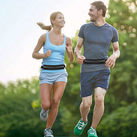 Two people jogging outdoors wearing Waterproof Running Belt Fanny Pack For Men And Women Slim Running Bag With Adjustable Elastic Belt