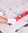Tile Leveling System Kit With 1000 Spacers One Sixteenth Inch Pro Grade Horseshoe U Shaped Clips in use on tiled floor