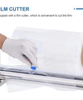 Close-up of manual stretch film winding machine with sliding cutter, accepting paper tubes up to 76 mm, for easy packaging.