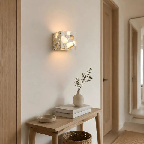4.7" Mid Century Modern Wall Sconce, Minimalist Terrazzo Wall Light Fixture illuminating a wall beside a wooden table.