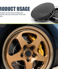 4 Pack Car Wheel Center Caps 2 In By 1.9 In By 0.6 In Snap In Hub Covers Black Weather Resistant And Durable installed on a vehicle rim.