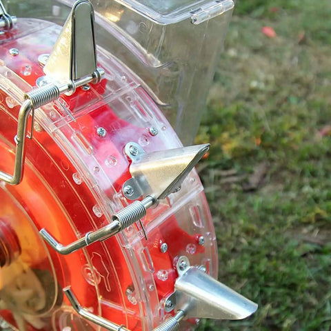 Close-up of Manual Seeder For Garden And Lawn, Metal Precision Seed Planter with transparent seed storage and 9 holes.