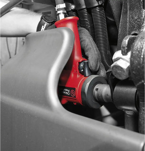 Half Inch Air Impact Wrench With Aluminum Body And Steel Front Cover Delivers 450 Foot Pounds Of Torque 610 Newton Meters 9000 RPM One Hand Operation Jumbo Hammer Ergonomic Pistol Grip For Heavy Duty Auto Shop Use being used on machinery