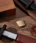 Brass Habaki Collar Clip For Swords With Vintage Golden Finish, handguard clip on wooden surface with sword accessories.
