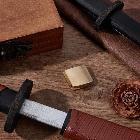 Brass Habaki Collar Clip For Swords With Vintage Golden Finish, handguard clip on wooden surface with sword accessories.