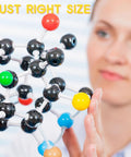Person examining Hands On Chemistry Molecular Model Kit With C60 Buckminsterfullerene, colorful atoms and bonds visible, just right size