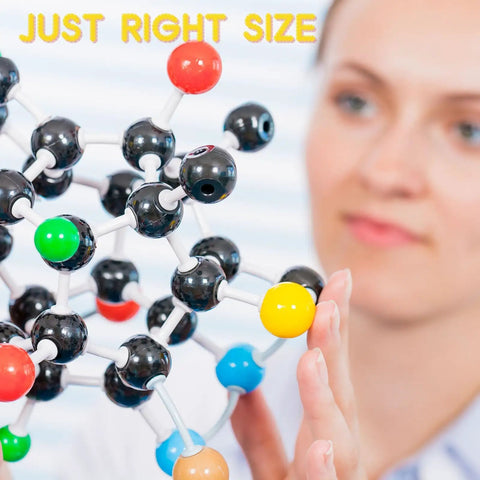 Person examining Hands On Chemistry Molecular Model Kit With C60 Buckminsterfullerene, colorful atoms and bonds visible, just right size