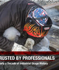 Welder wearing All American Stars And Stripes Welding Cap With Mesh Inside Liner, working on railway tracks, flame design helmet.