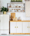 Stylish golden drop pendant pulls on white kitchen cabinets with fridge and shelving, featuring 16 Pack Ginkgo Leaf Knob Handles Set.