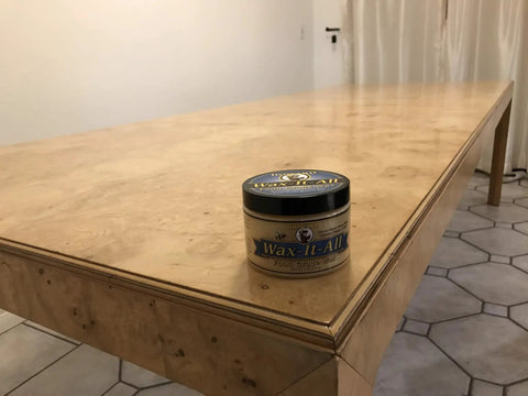 Real Deal Food Grade Beeswax Wood Polish And Cutting Board Wax, Nine Oz Jar on a polished wooden dining table.