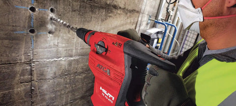 Worker using Beast 120 Volt SDS Max Corded Rotary Hammer Drill Kit with AVR Vibration Reduction Includes TE 70 Rotary Hammer