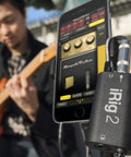 Musician using iRig 2 Portable Guitar Interface For iPhone iPad And Mac Lightweight Audio Adapter with instrument and amplifier