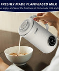 8 In 1 Nut Milk Maker Blender 32oz Capacity for Creamy Soy Almond Oat Coconut and Plant Based Non Dairy Beverages with Delay Start and Keep Warm for Easy Homemade Milks pouring milk