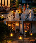 Four Pack Solar Lanterns With Flickering Flame, outdoor waterproof hanging lights with rustic hemp rope handle illuminating pathway.
