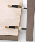 Twenty Four Piece 35 mm Cam Screw And Dowel Pin Kit With Zinc Connectors showing cam screws fastening wooden boards together.