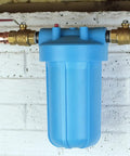 OmniFilter BF7 10 Inch Whole House Water Filtration System with Big Blue Housing installed on wall with copper piping
