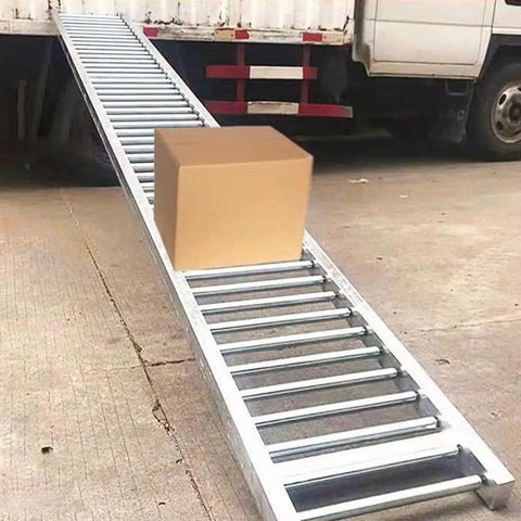 Hella Tough Galvanized Steel Gravity Conveyor Rollers with cardboard box on ramp for warehouse material handling.