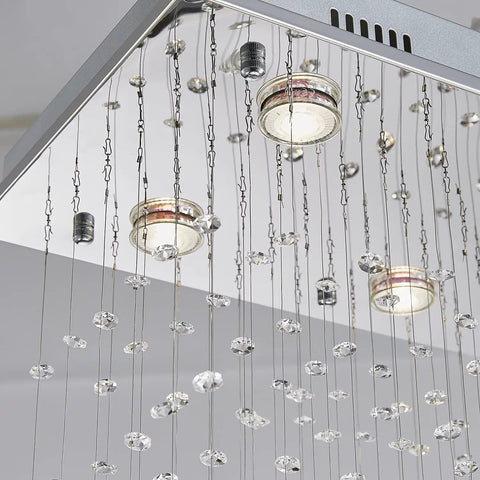 Close-up of Lit 8 Light K9 Crystal Modern Flush Mount Ceiling Light Fixture With Raindrop Crystal Chandelier Glass Drops, bulbs visible