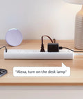 Six Outlet Smart Power Strip With Usb C Charging, Alexa Enabled Wifi Extension Cord on a desk with a lamp and phone.