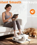 Woman using Under Desk Elliptical Pedal Exerciser For Home Office, Portable Seated Leg Exerciser With 15 Speeds, dog resting nearby.