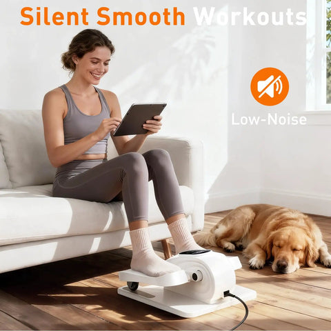 Woman using Under Desk Elliptical Pedal Exerciser For Home Office, Portable Seated Leg Exerciser With 15 Speeds, dog resting nearby.