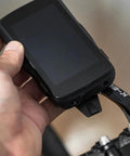 Hand holding the Max XL 31.8mm Bicycle Computer Combo Mount for Garmin GPS Devices Black Easy Install on handlebar