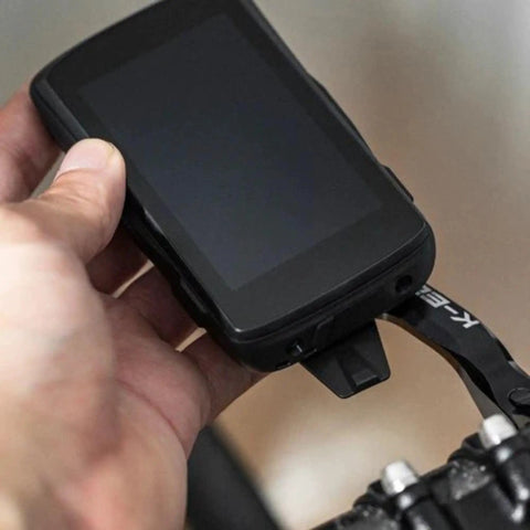 Hand holding the Max XL 31.8mm Bicycle Computer Combo Mount for Garmin GPS Devices Black Easy Install on handlebar