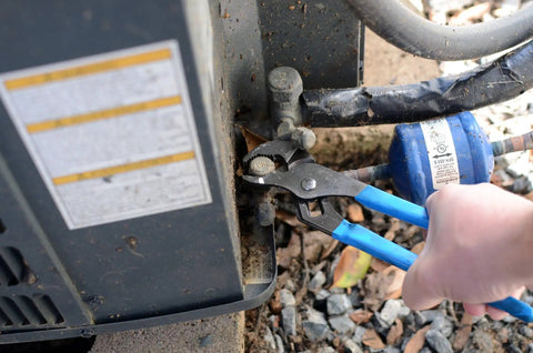 V Jaw Tongue And Groove Pliers Set With Dipped Handles adjusting pipe fitting next to utility box during home repair