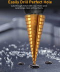 Gold woodworking stepped drill bit close-up with size markings, drilling into a dark work surface.