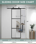 Clear Tempered Glass Barn Door 28 Inch By 84 Inch With Carbon Steel Frame Pre Drilled For Easy Assembly Including 5 Foot Hardware Kit And Soft Close System For Smooth Sliding And Modern Interior Spaces shown in installed position.