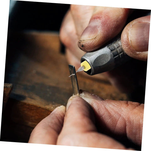 Close-up of a hand using a tool with a tungsten steel bit for jewelry crafting from the 30-Piece Cobalt PCB Drill Bit Set For Circuit Board Engraving And Jewelry Crafting With Micro Metric Tungsten Steel Bits For Drill Press And Precise Piercing On Small Electronics Projects.