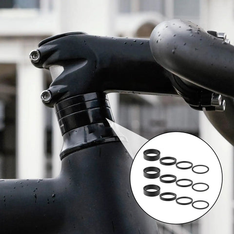 Twelve Piece Aluminum Alloy Bike Stem Spacers Set For One And One Eighth Inch Headset Spacers shown on a bike handlebar