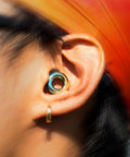 Person wearing Experience 2 Ear Plugs For Concerts And Festivals With High Fidelity Sound And 17dB Noise Reduction in ear close-up